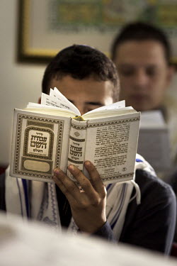 A boy prays during a service in a synagogue. He belongs to a community, one of many worldwide, of so-called 'lost Jews'. These communities, often previously Christians, claim a historic link with Juda...