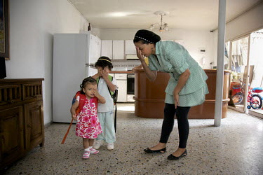 Galit  Zapata prays with her 4 year old son, Baruj, and two year old daughter, Gabriela, before the children leave for kindergarten. They belong to a community, one of many worldwide, of so-called 'lo...