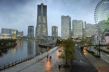The harbour and office blocks illuminated at dusk. At 296 metres the Landmark Tower is the city's tallest building.