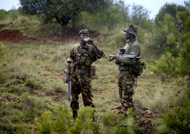 Rangers from the Lewa Wildlife conservancy drink water during a patrol protecting Rhino from the ever present threat of heavily armed poachers. The Lewa Wildlife Conservancy, a non profit organisation...