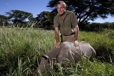 Ian Craig wih a young hand reared Rhino at the Lewa wildlife conservancy.The Lewa Wildlife Conservancy, a non profit organisation, was created by Ian Craig out of his parent's cattle ranch in the 1980...