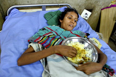 Amena eats her lunch in her hospital bed at the Pongu Hospital in Dhaka. She sustained a spinal injury when the Rana Plaza complex in Savar on the outskirts of the city collapsed, killing over 1,000 a...