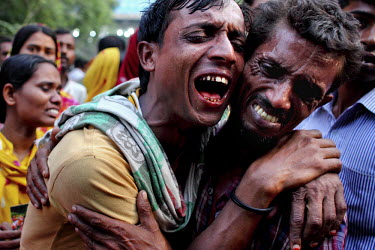 Relatives of dead and missing garment workers mourn and wail outside the collapsed Rana Plaza complex in Savar.The 8 storey Rana Plaza complex, which housed a number of garment factories employing ove...