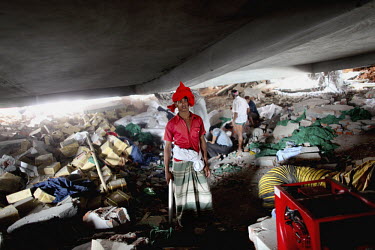 A civilian helper searches for survivors amongst the rubble of the collapsed Rana Plaza complex on the outskirts of Dhaka.The 8 storey Rana Plaza complex, which housed a number of garment factories em...