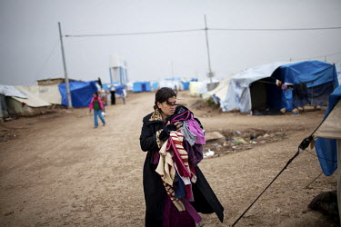 A Syrian refugee walks around the camp. Domiz Refugee Camp run by UNHCR was established by local authorities in April 2012 to host the Syrian Kurds. The camp located 20 kms southeast of Dohuk city, in...