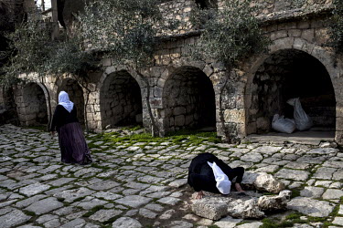 Yazidi women pray at a shrine in the city of Lalish. The Yazidi are a Kurdish ethno religious group. They adhere to a branch of Yazdanism that blends elements of Mithraism, pre-Islamic Mesopotamian re...