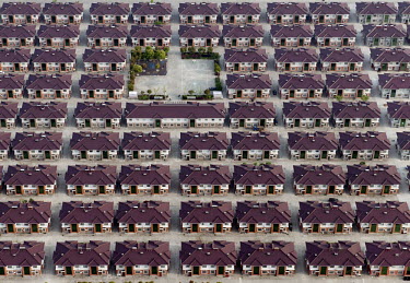 Rows of identical houses with a playground seen in the middle in the city of Jiangyin.
