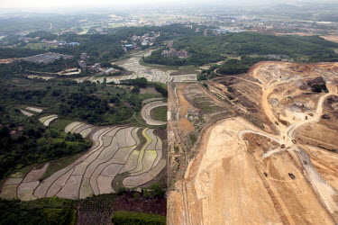 Agricultural land and rice fields next to land being cleared in the city of Nanning.