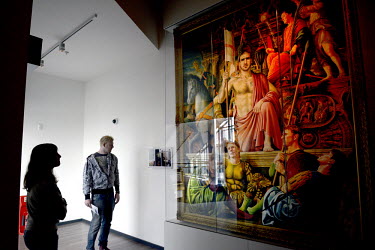 Visitors look at a surreal painting, called The Art of the Game by Michael Browne, of the Eric Cantona and other members of the 1995 Manchester United Football Club at the National Football Museum in...