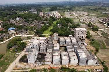 New buildings and fields on the edge of a village in Shibuzhen.