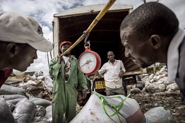 Ecopost employees weigh and buy plastic at Dandora dump. By truck it is transported to the Ecopost factory. All domestic and industrial waste is dumped here. EcoPost Ltd is a for profit social enterpr...