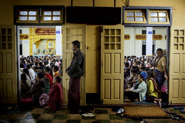 Followers of U Wirathu, the spiritual leader of the radical Buddhist 969 movement, watch him deliver a sermon on a projector screen in an overflow area of the Thein Taung Monastery in Taunggyi, Shan S...