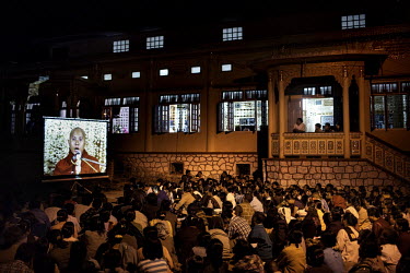 Followers of U Wirathu, the spiritual leader of the radical Buddhist 969 movement, watch him deliver a sermon on a projector screen in the overflow area of the Thein Taung Monastery in Taunggyi, Shan...