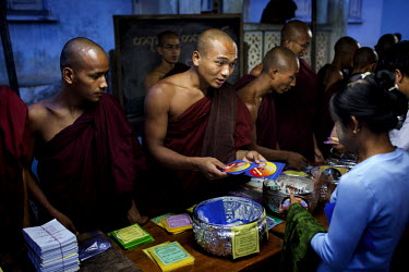 Followers of U Wirathu, the spiritual leader of the radical Buddhist 969 movement, buy 969 DVDs and stickers from monks before Wirathu delivers a sermon at Thein Taung Monastery in Taunggyi, Shan Stat...