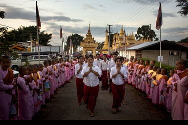 Followers of U Wirathu, the spiritual leader of the radical Buddhist 969 movement, follow his convoy into Thein Taung Monastery before he delivers a sermon in Taunggyi, Shan State.