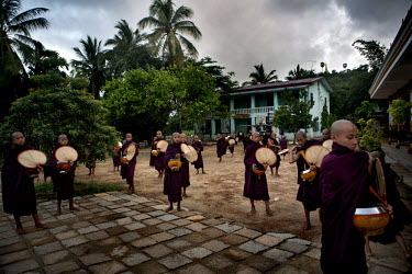Monks from the Myazeda Man Oo Monastery, where they produce promotional material and literature for the Buddhist nationalist 969 movement, prepare to go on their rounds to collect morning alms in Mawl...