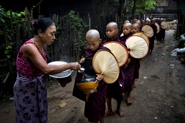 Monks from the Myazeda Man Oo Monastery, where they produce promotional material and literature for the Buddhist nationalist 969 movement, go on their rounds to collect morning alms in Mawlamyine, Mon...