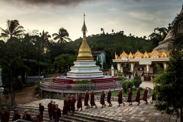 Monks from the Myazeda Man Oo Monastery, where they produce promotional material and literature for the Buddhist nationalist 969 movement, file into evening prayers in Mawlamyine, Mon State.