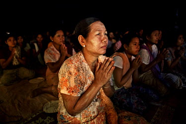 Supporters from Kyaw Min pray as U Wirathu (unseen), the spiritual leader of the Buddhist nationalist 969 Movement, gives a sermon at the Shwe Areleain Monastery in Kyaw Min Village, Myiamu Township....