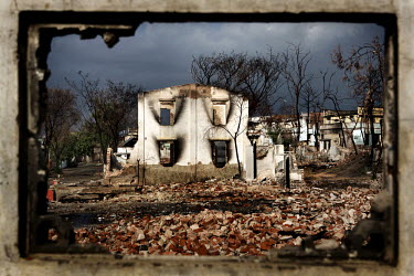 Burned trees and damaged buildings are seen through the window of a destroyed house in the Mingalar Zayyone Muslim quarter, that was razed by Buddhists in ethnic violence in March, in Meikhtila. The n...