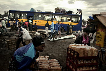 Traders sell bread and people mill around in front of a bus in the Mbare area of Harare, the Zimbabwean capital. Mbare was established in 1907. It was originally called Harare Township, a name later t...