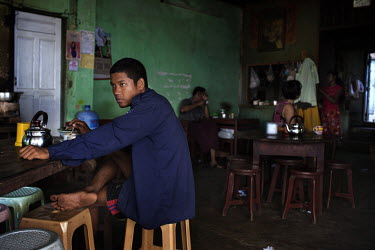 Burmese people from various ethnic backgrounds sit in a tea shop in Mawlamyine.