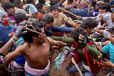 People participate in ritual fighting in the plaza of Macha.   The people of Macha and surrounding communities carry on the pre-Columbian tradition of ritual fighting. The communities gather on the pl...