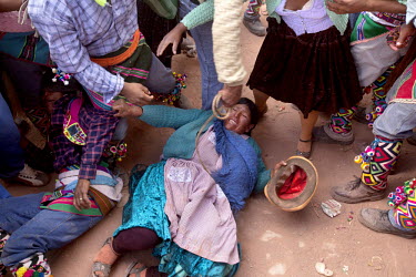 A woman gets knocked down during the ritual fighting in the plaza of Macha.   The people of Macha and surrounding communities carry on the pre-Columbian tradition of ritual fighting. The communities g...