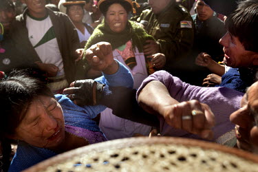 Women participate in ritual fighting in the plaza of Macha.   The people of Macha and surrounding communities carry on the pre-Columbian tradition of ritual fighting. The communities gather on the pla...