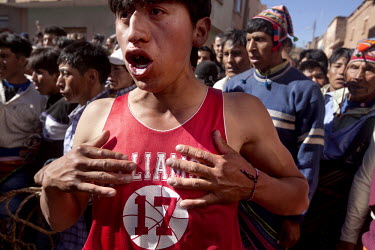 A man in a baseball T shirt growls during the ritual fighting in the plaza of Macha.   The people of Macha and surrounding communities carry on the pre-Columbian tradition of ritual fighting. The comm...
