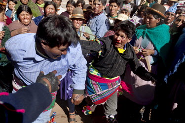 People participate in ritual fighting in the plaza of Macha.   The people of Macha and surrounding communities carry on the pre-Columbian tradition of ritual fighting. The communities gather on the pl...