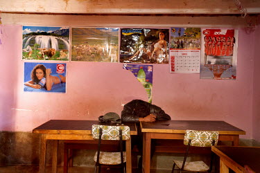 A man sleeps on a table in a small community near Macha.   The people of Macha and surrounding communities carry on the pre-Columbian tradition of ritual fighting. The communities gather on the plaza...
