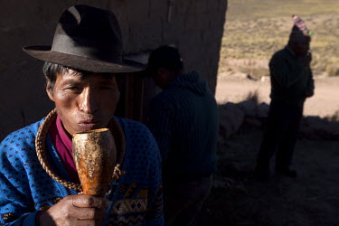 A man drinks chicha, a popular drink in South America often made from maize or fruit, in a small community near Macha.   The people of Macha and surrounding communities carry on the pre-Columbian trad...