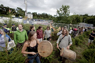 Protesters start to form a human chain around the site where Cuadrilla, an energy company, is drilling for oil and gas in Balcombe, West Sussex. Some are playing drums and chanting. The protesters at...