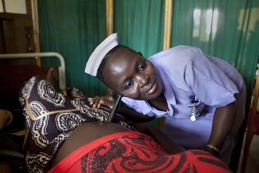 Sia Sandi, student midwife from The School of Midwifery in Masuba, Makeni examines a patient at Makeni Regional Hospital. Her training is being funded by H4+. The H4+ (made up of UNAIDS, UNFPA, UNICEF...