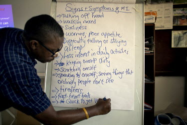 A tutor writes a list of symptoms of mental illness during mental health training for nurses supplied by the Carter Centre at the Phebe Hospital.