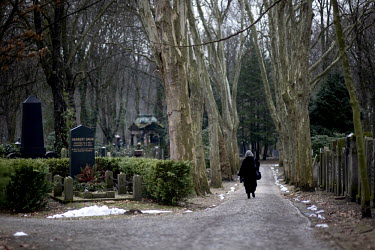 A woman walks past Herbert Baum's tombstone in the Weissensee Cemetery, the biggest Jewish cemetery in Europe. Baum was an anti-Nazi Jewish resistance leader who was murdered by the Gestapo in Moabit...