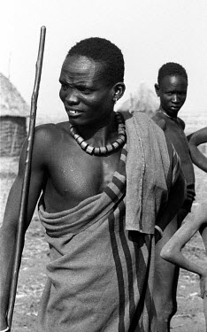 A Nuer man in a cattle camp on the banks of the Baro River. The parallel scars on his forehead are a sign of his manhood. Every cattle breeding ethnic group in the region has different scar patterns....