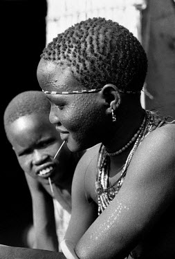 Nuer women in a cattle camp on the banks of the Baro River. The Nuer are traditionally cattle breeders and migrate between their villages where they live during summer to temporary cattle camps in win...