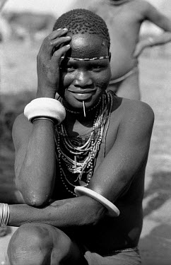 A Nuer woman in a cattle camp on the banks of the Baro River. The Nuer are traditionally cattle breeders and migrate between their villages where they live during summer to temporary cattle camps in w...