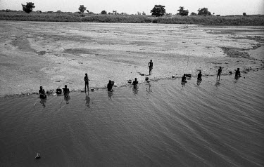 Nuer fishing in the Baro River. The Nuer are traditionally cattle breeders and migrate, between their villages where they live during summer to temporary cattle camps in winter. They are a minority in...
