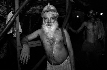 A bare chested miner in an underground tunnel in one of Tata Steel's coal mines.