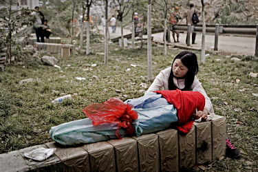 A woman sits with the body of her three year old son who died in the 12 May 2008 earthquake. The magnitude 8 tremor hit Sichuan at 14.30 on 12 May. 69,000 people were declared to have died with a furt...