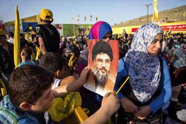 A boy hold a poster of Hezbollah leader Hassan Nasrallah during a rally marking  Liberation Day, the day Israel withdrew from south Lebanon in 2000. In the speech at the event Nasrallah confirmed, for...