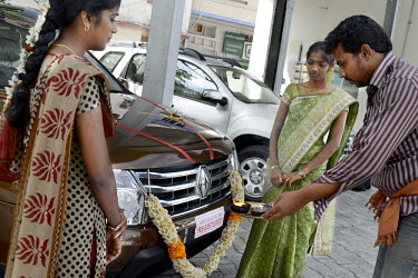 An offering is made after the sale of a new Renault vehicle at the showroom.