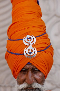 A Sikh warrior wearing a ceremonial orange turban at the Gurdwara Sisganj.