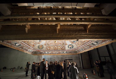 Visitors look at the reconstruction of a synagogue roof, a replica of the wooden Gwozdziec Synagogue, at the Museum of History of Polish Jews, designed by Finish architects Rainer Mahlamaeki and Ilmar...