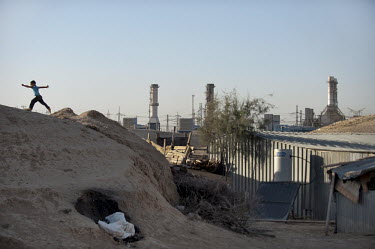 A child runs over a hill in the unrecognised Bedouin village of Wadi el Na'am which stands next to an Israel Electric Corporation's power station and the Ramat Hovav hazardous waste disposal facility...