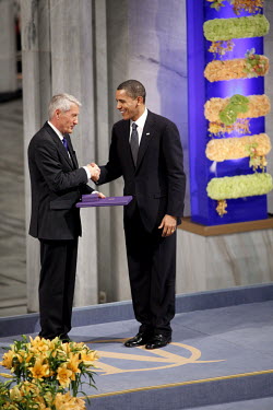US President Barack Obama accepts the Nobel Peace Prize from Nobel Committee Chairman Thorbjorn Jaglandduring during a ceremony in Oslo Town Hall.
