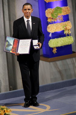 US President Barack Obama with the Nobel Peace Prize during a ceremony in Oslo Town Hall.
